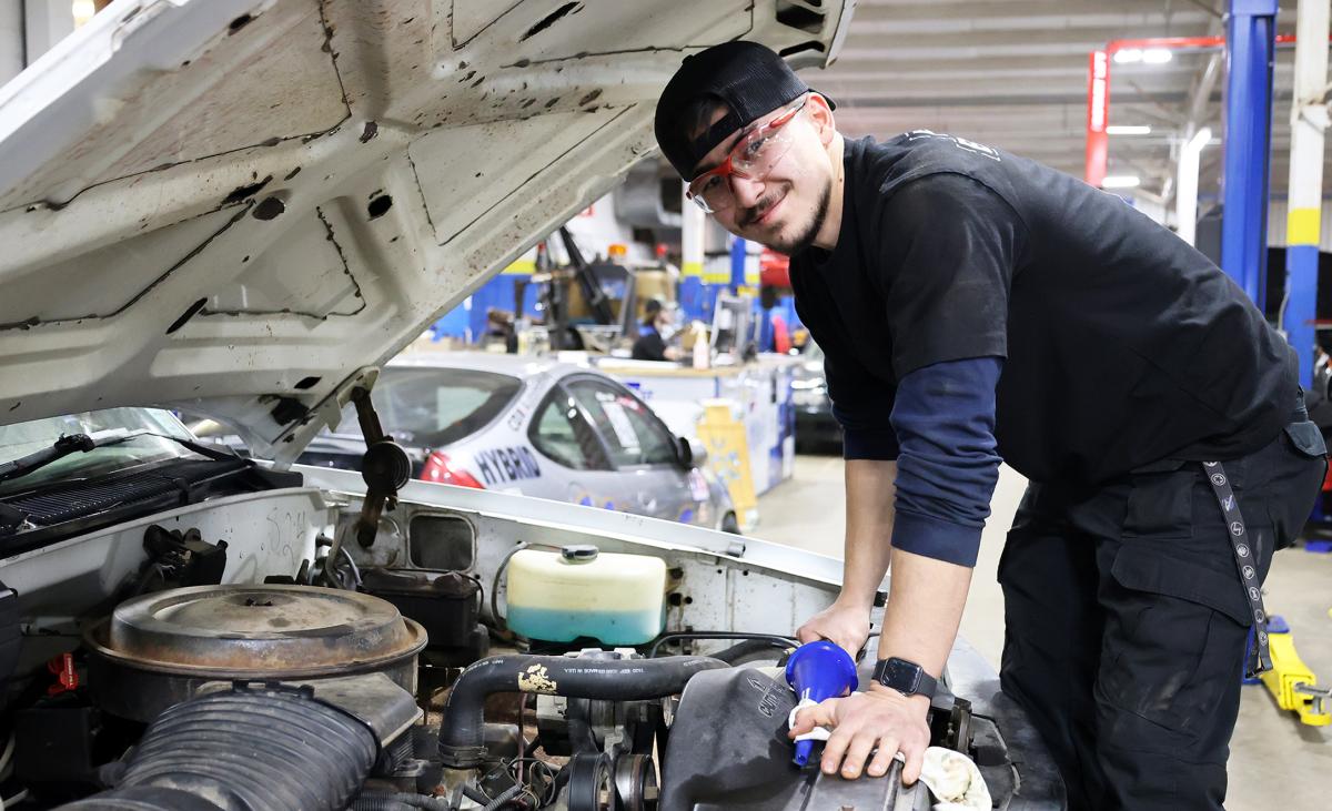 student working on a car