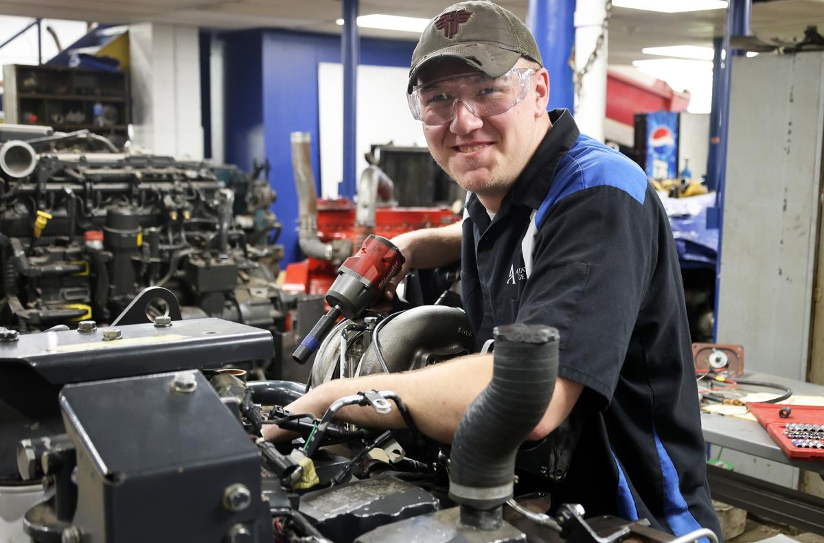 student works in the auto shop