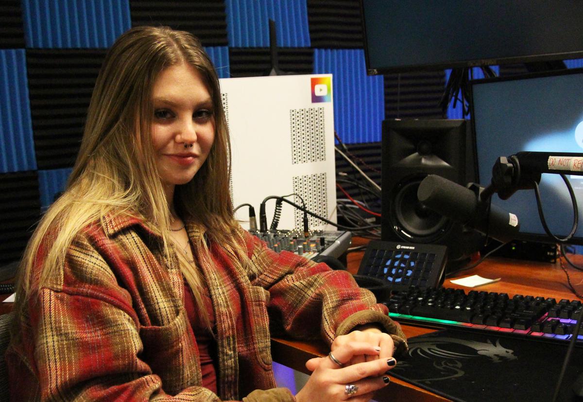 Students sits in the recording studio