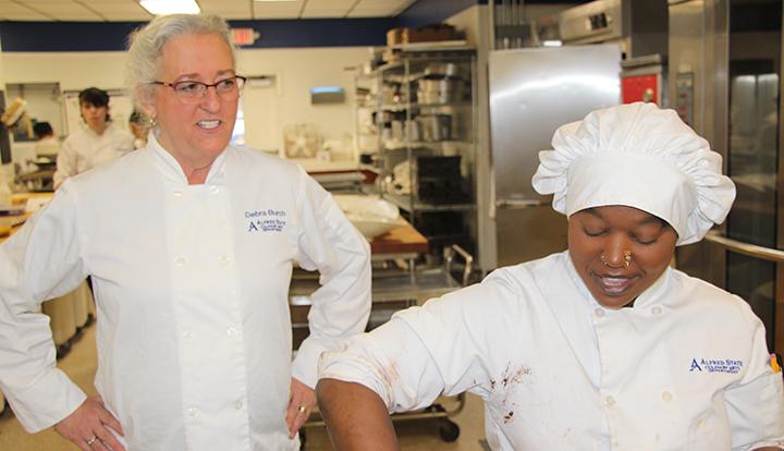 Deb Burch works with a baking student