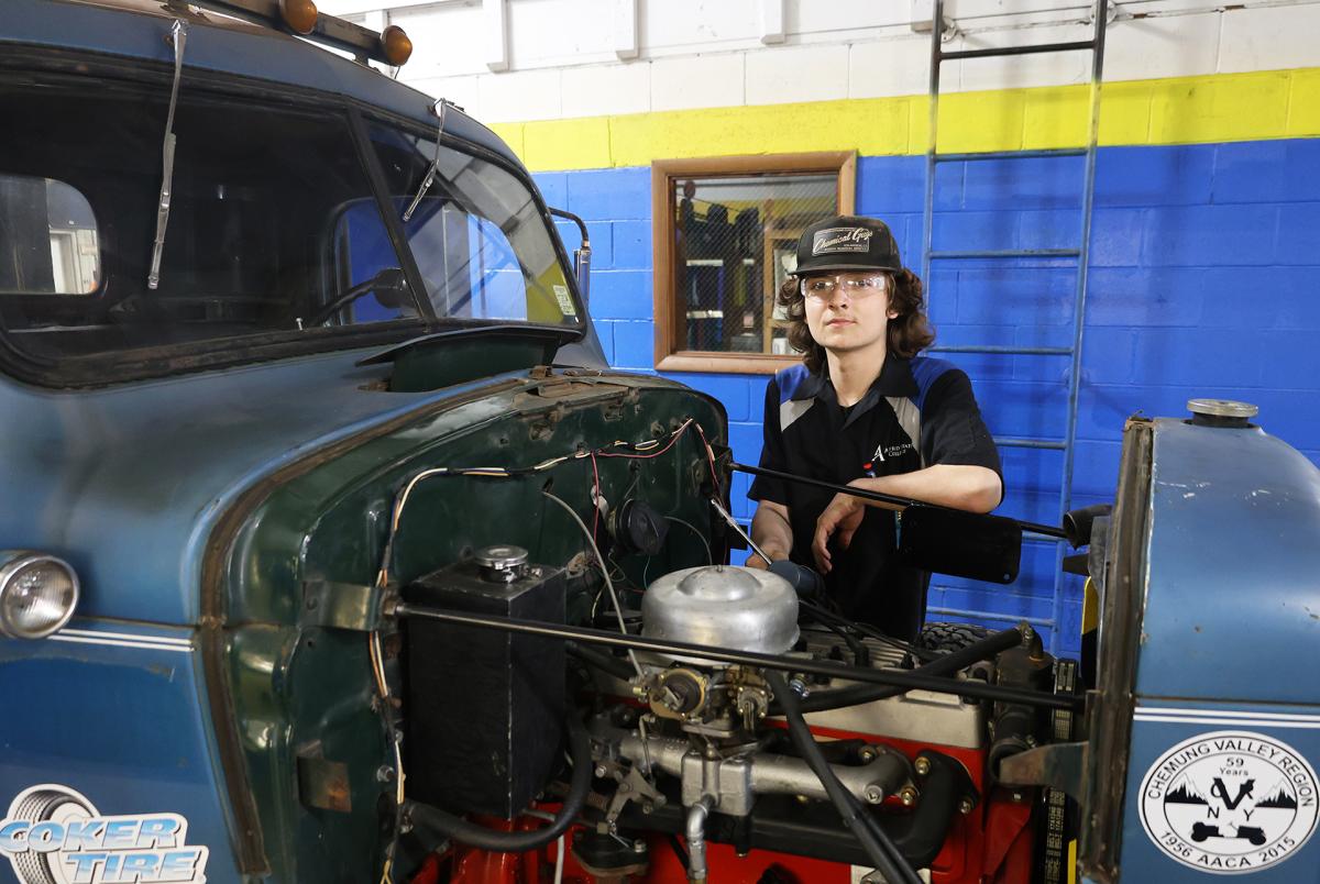 student working on a tow truck