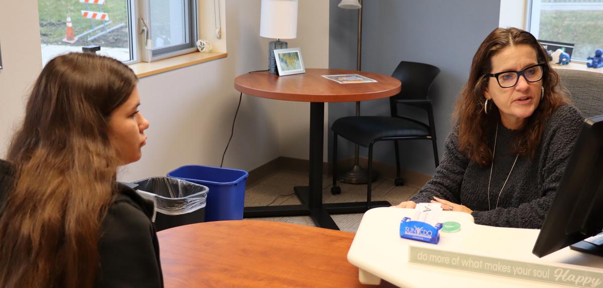 student sits with career development employee