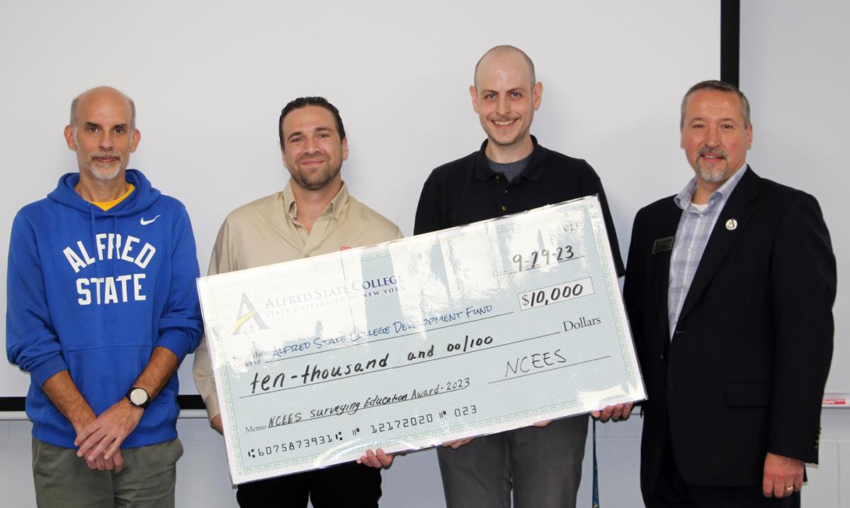 Alfred State faculty accept a check for $10,000