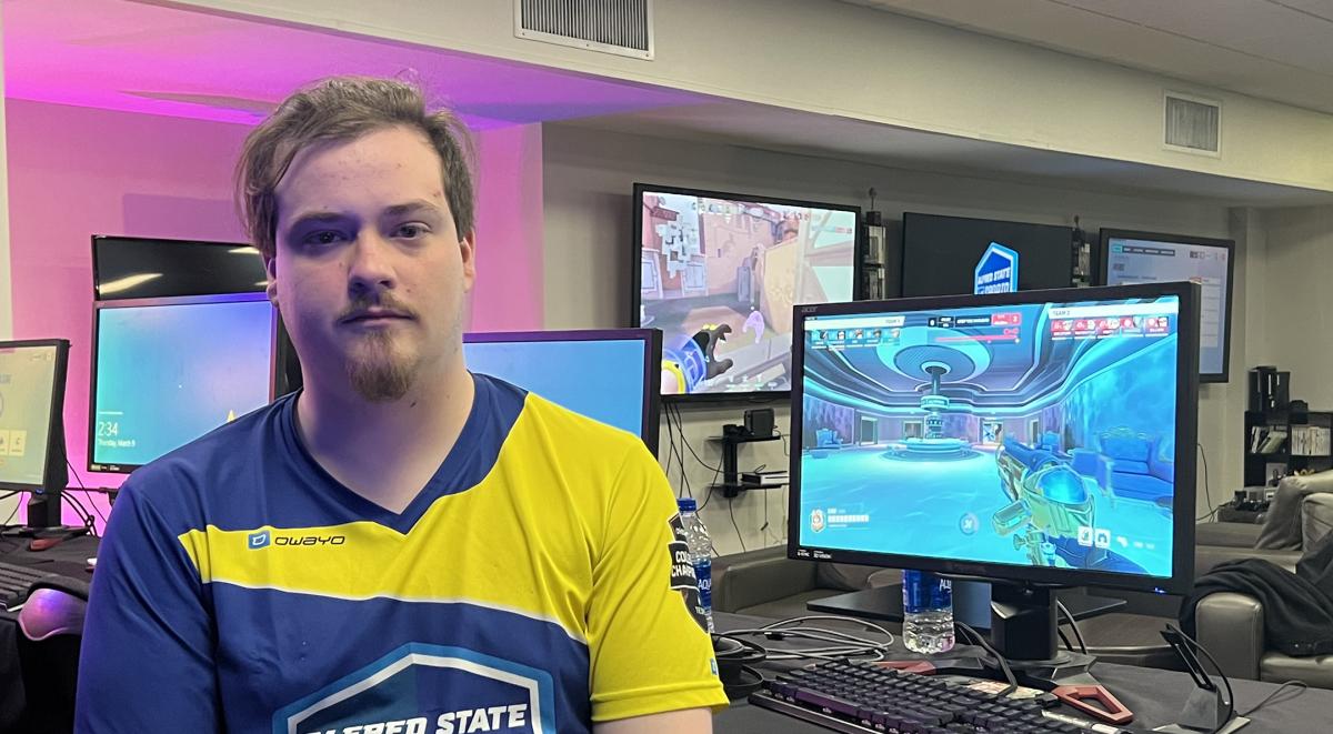 Austin Clay sits in front of a laptop prior to playing in an Esports competition.