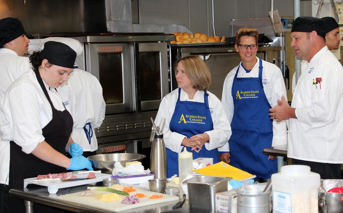 Students work with faculty in the kitchen