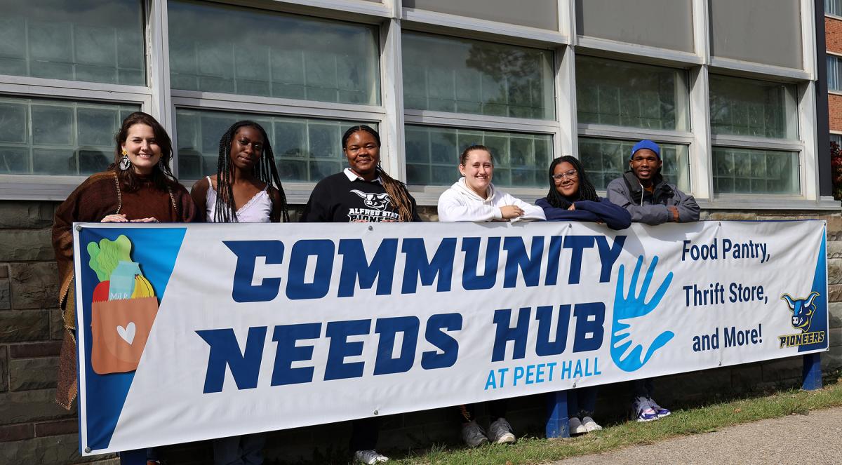 Staff of the Community Needs Hub stands outside their new space