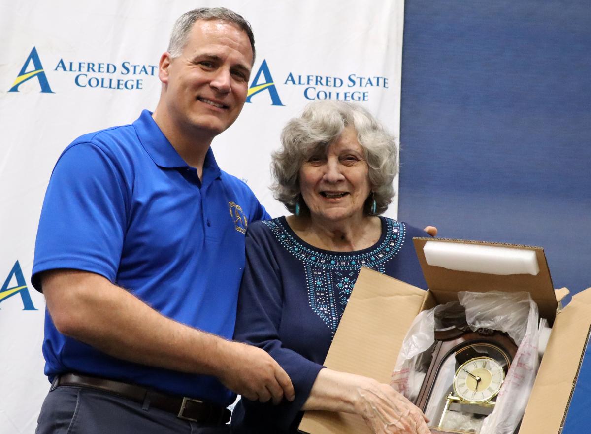 Dr. Constantine is presented a clock by Dr. Mauro