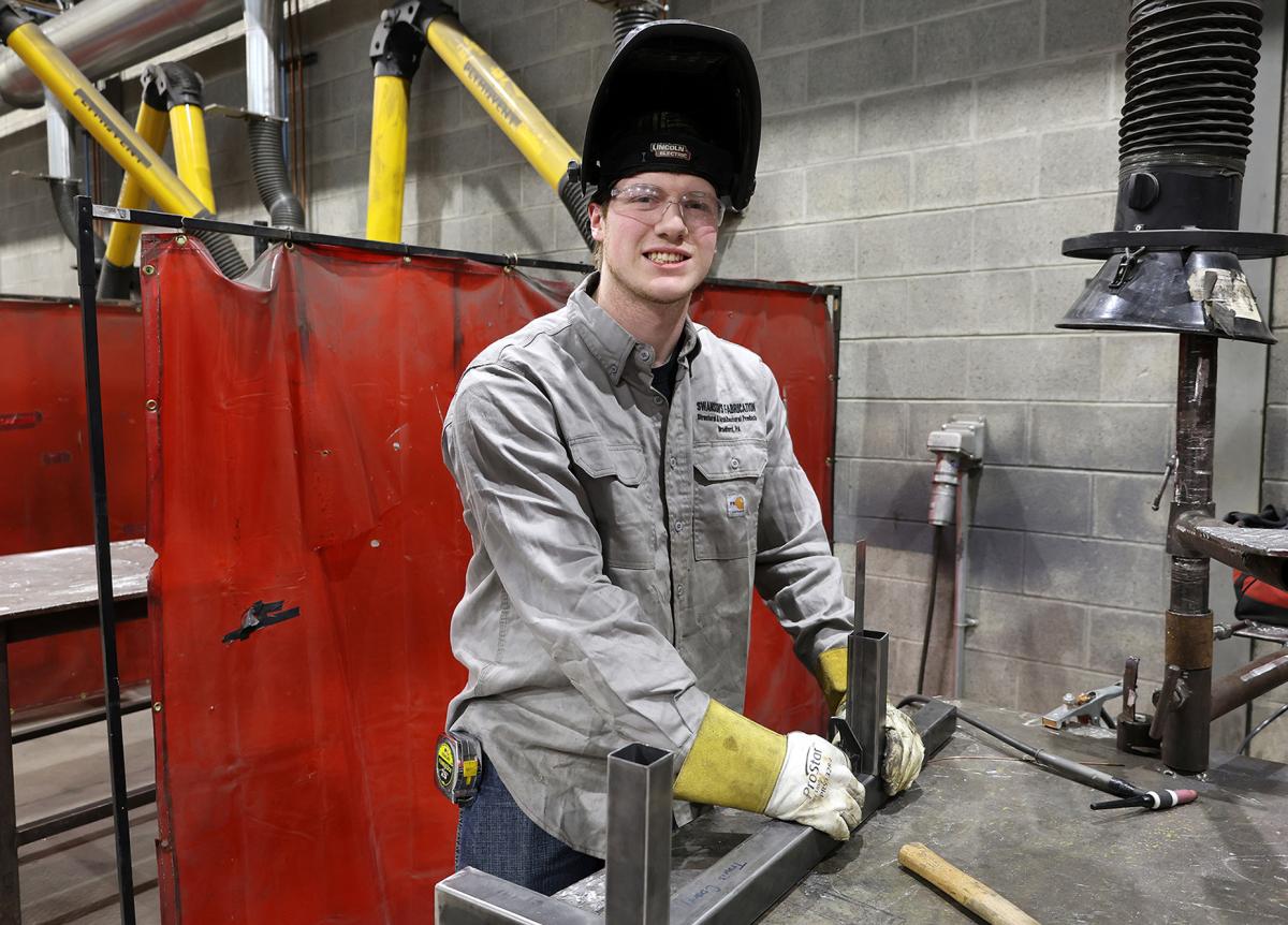 student takes a break in the welding lab