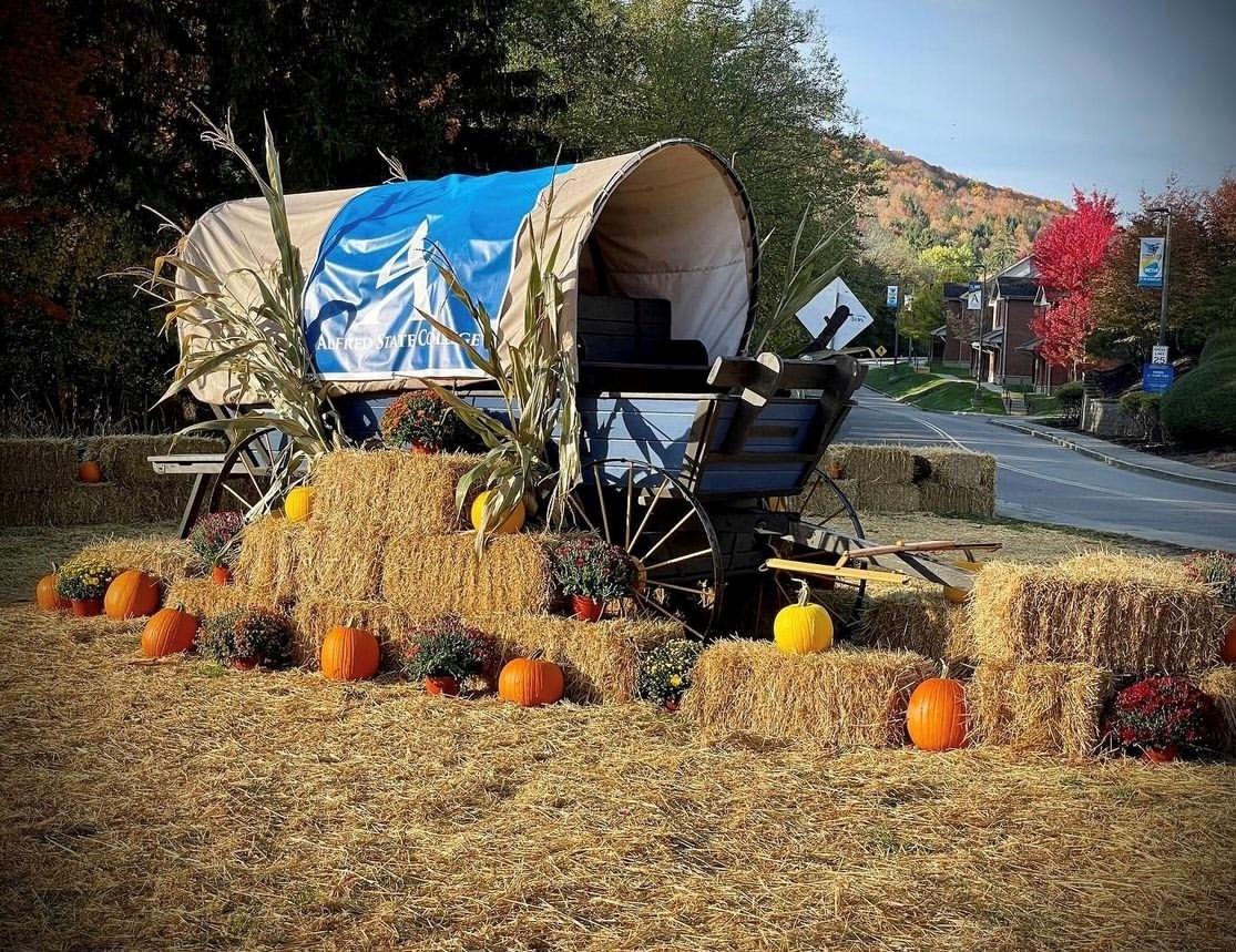 Covered wagon display at the main entrance of Alfred State College.
