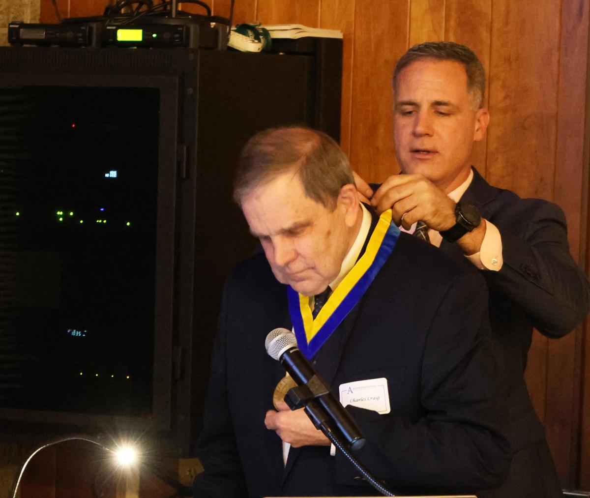 Dr. Mauro put the President's Medallion on Charles Craig