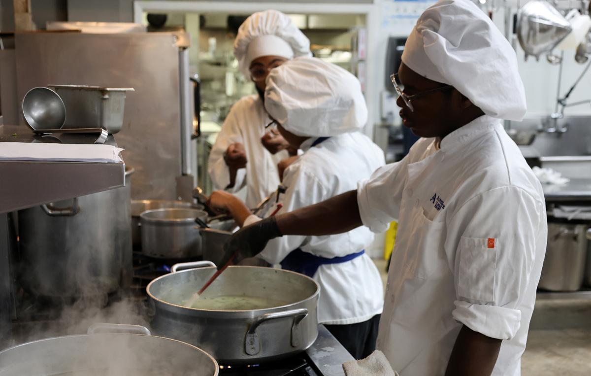 Students working near a stove