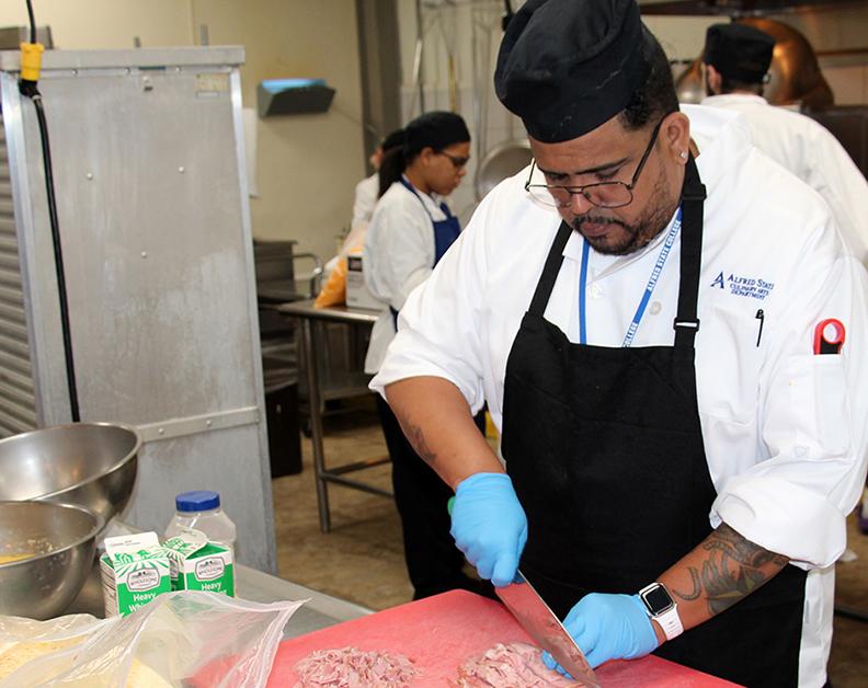 student cutting meat