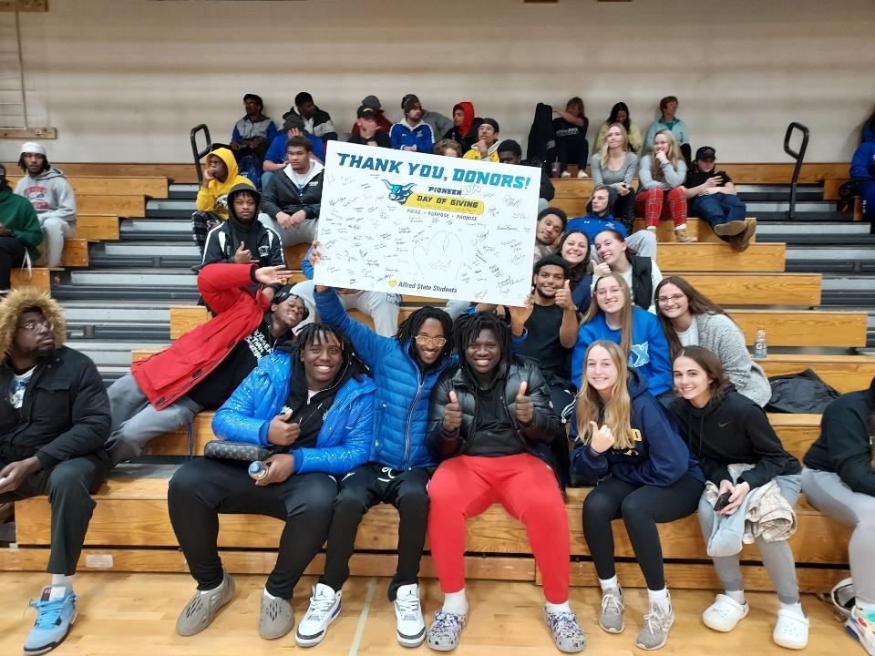 ASC students display a Thank You Donors sign.