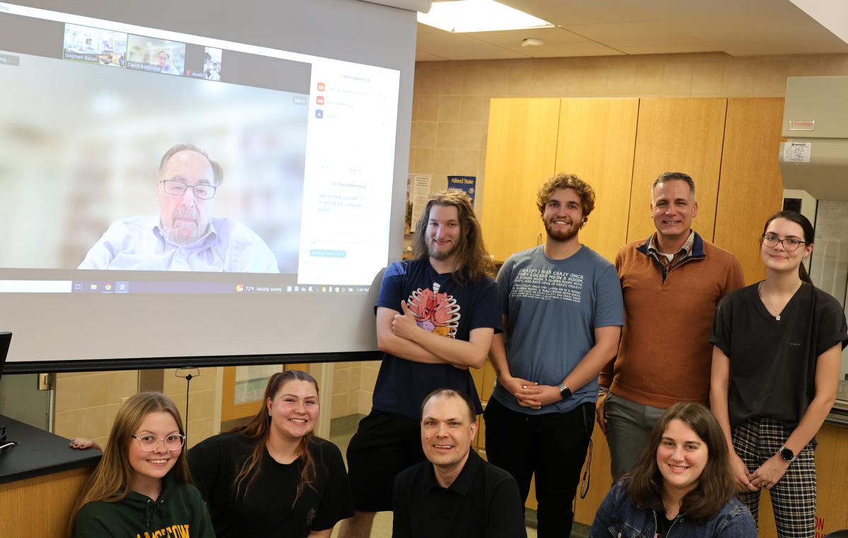 Students pose with Dr. Baltimore