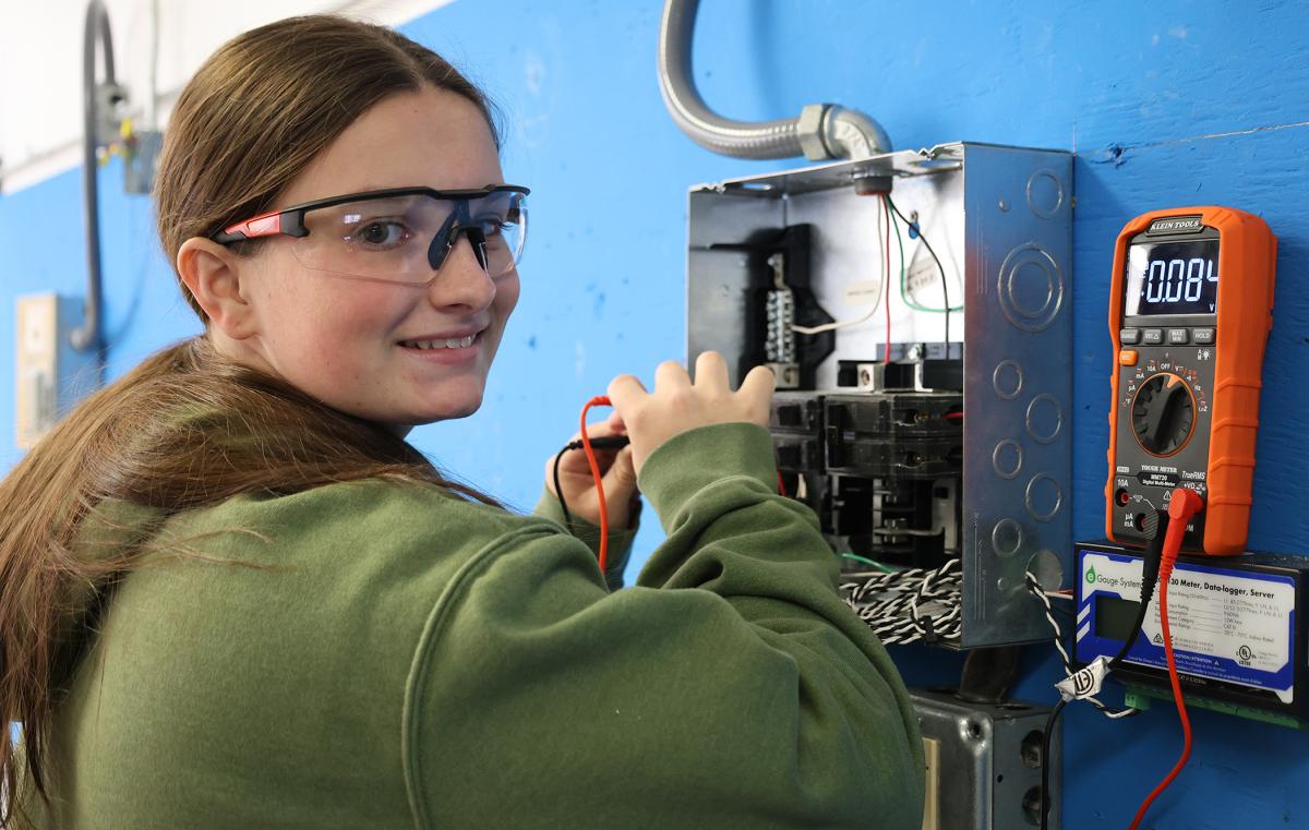 student works in an electric panel