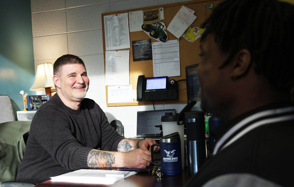 Students speaks with financial aid counselor