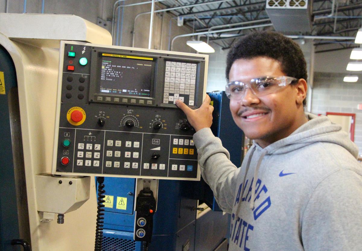 student works on a CNC machine