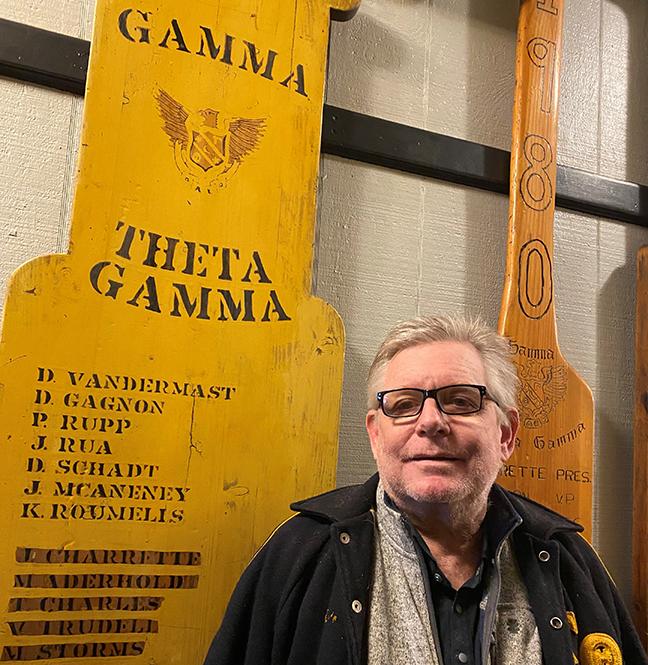 David Gagnon stands next to his pledge class paddle.