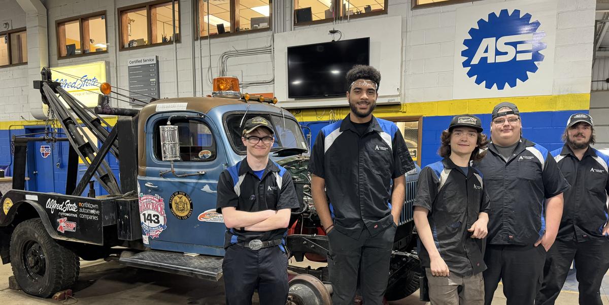 Alfred State students in front of a 1953 Dodge Power Wagon tow truck