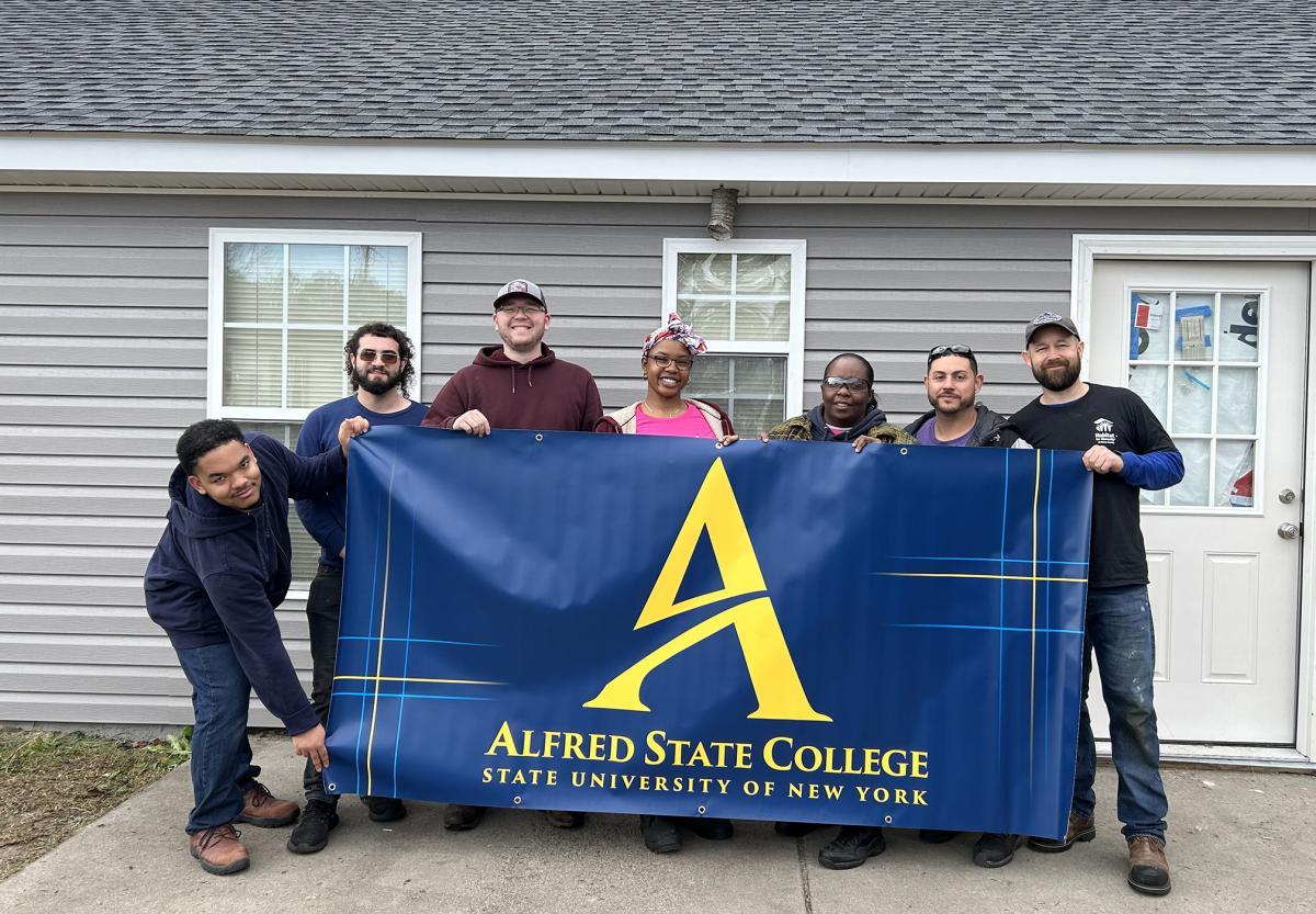 ASC students outside the house they worked on with Habitat for Humanity