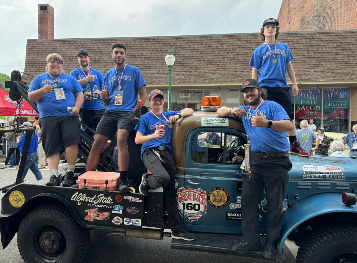 students pose with the 1953 Dodge Power Wagon driven during The Great Race