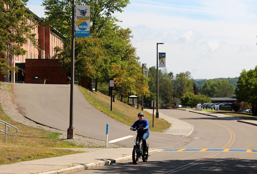 A student tests out one of the new electric bikes.