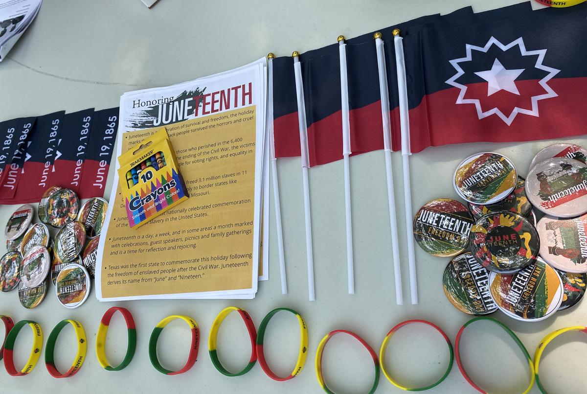 The Cultural Life Center provided information, buttons, and flags about Juneteenth at the Alfred Farmers Market