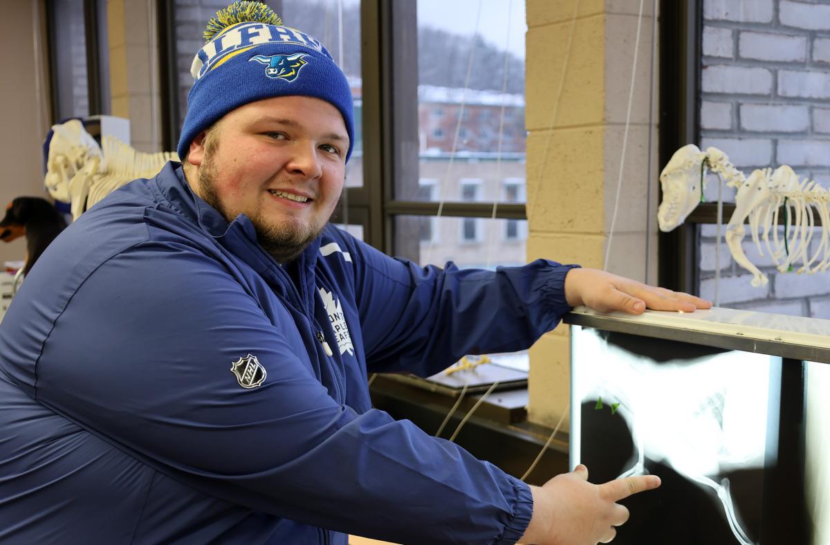 smiling student as he looks at x-rays