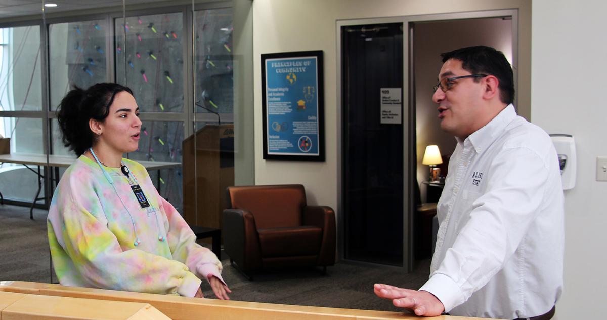 lfred State Chief Diversity Officer and Title IX Coordinator Matt Ryan talks with a student outside of his office in the Student Leadership Center.