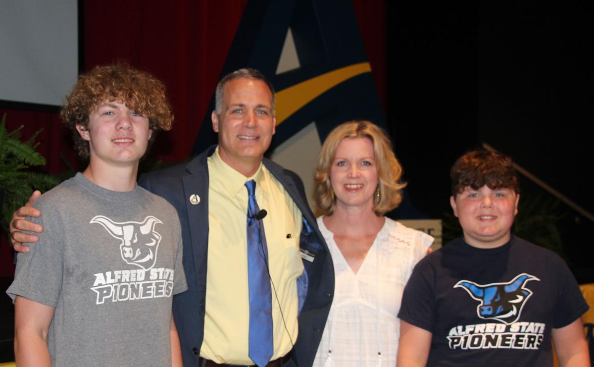 Dr. Steven Mauro poses with his wife Melissa and his sons Owen and Quinn prior to the start of his State of Alfred State address.