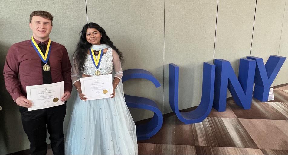 Soumya Konar and Noah Bastedo pose near the SUNY sign after receiving the Chancellor’s Award for Student Excellence in a ceremony held in Albany.