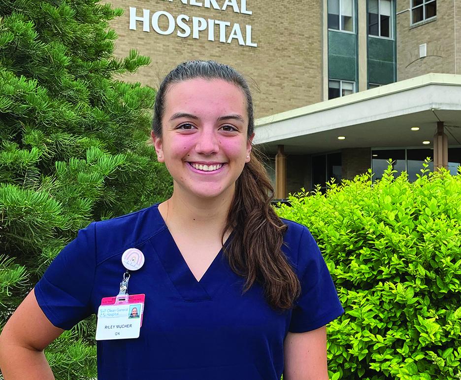 Riley Mucher stands outside a hospital
