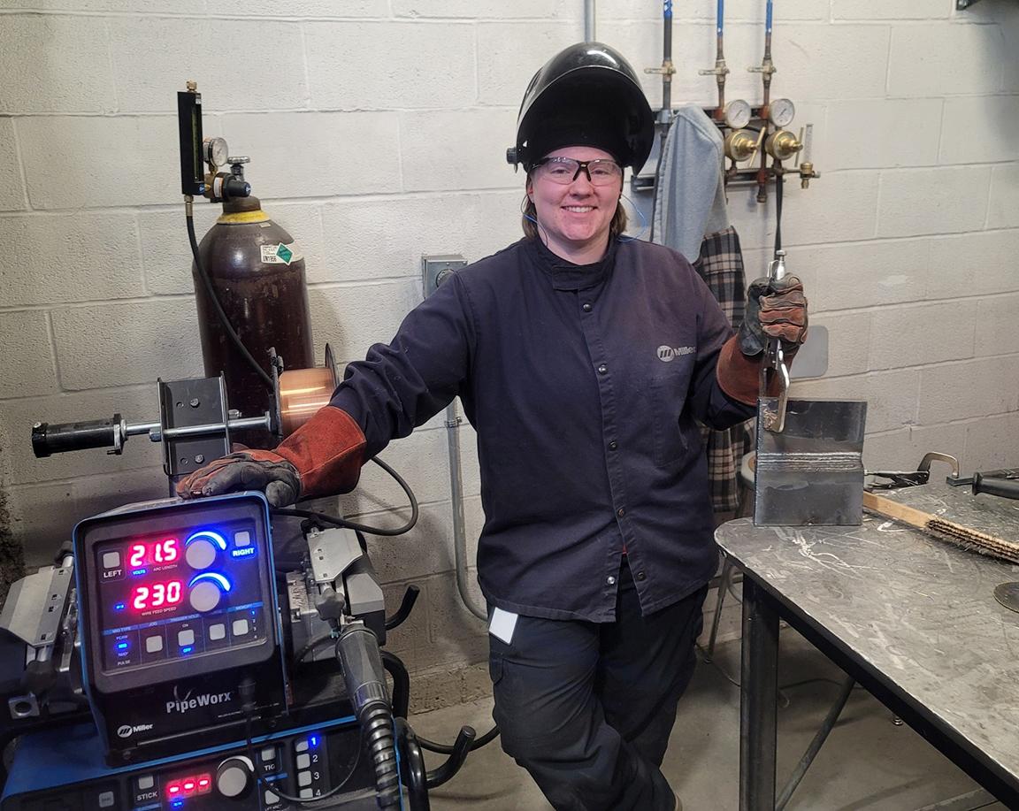 Alfred State welding student Delaney Nichols stands outside her booth. Nichols was named a winner of the Vanguard Award. She is the first Northland student to receive this honor.