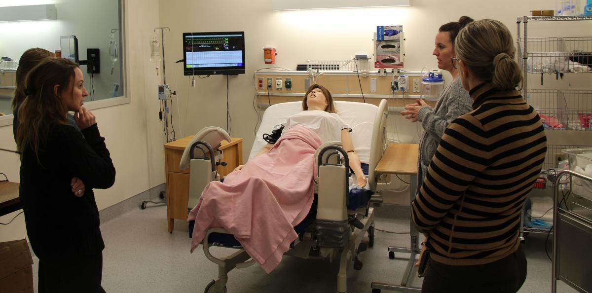 Alfred State assistant nursing professor Tara Histed shows a group of attendees to the healthcare forum one of the simulation labs that students receive hands-on instruction.