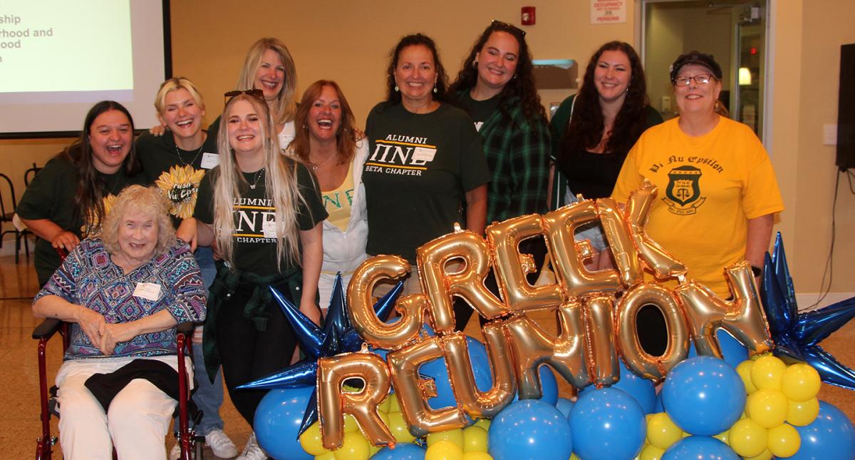 member of Pi Nu Epsilon pose at the Greek Reunion