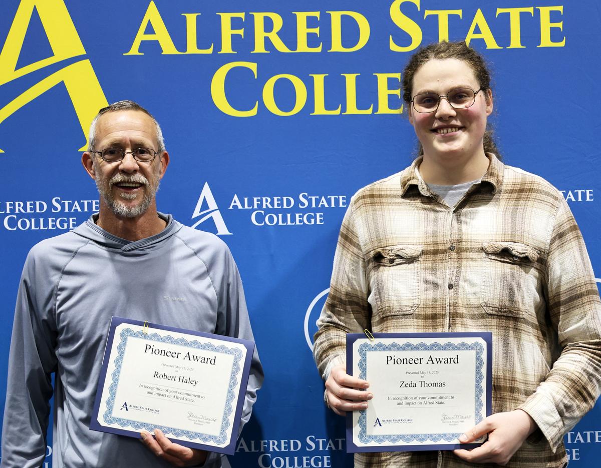 Bob Haley and Zeda Thomas display their awards