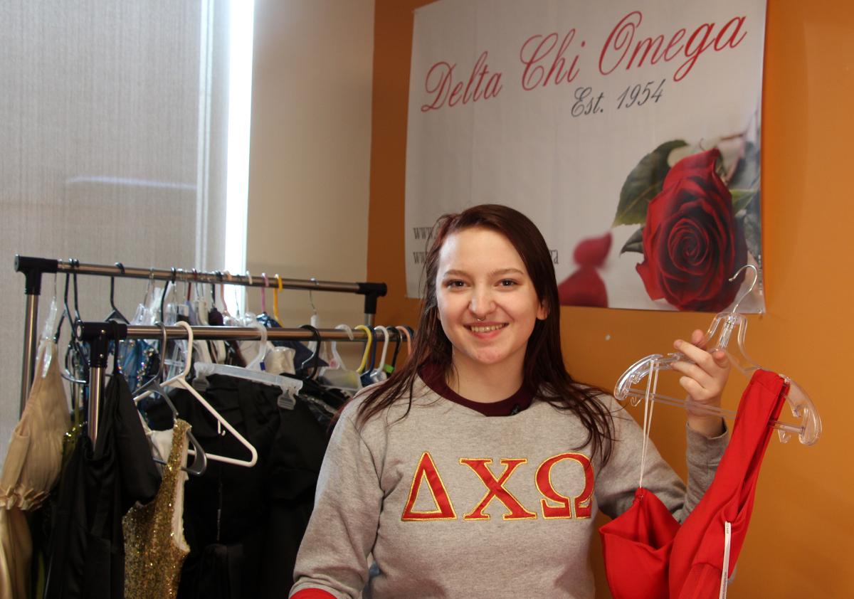 students holding a dress