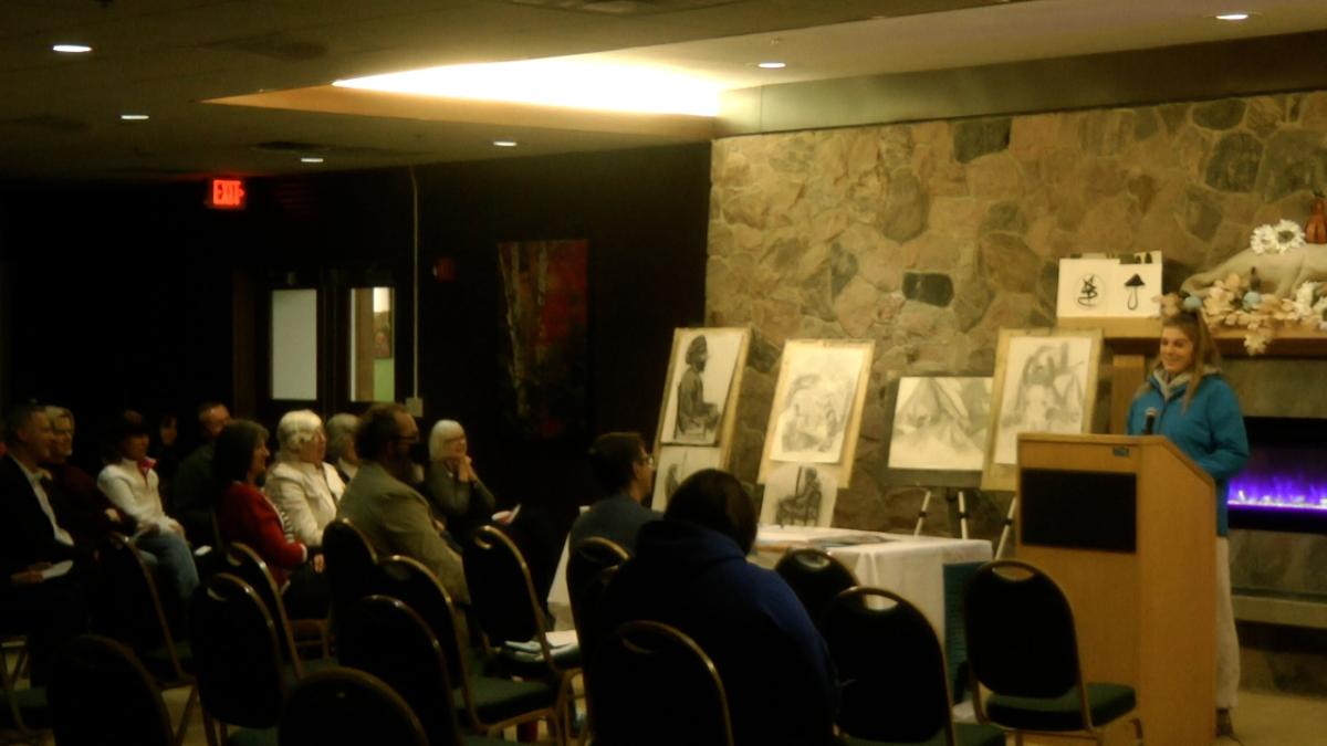 An Alfred State student recites an original poem.