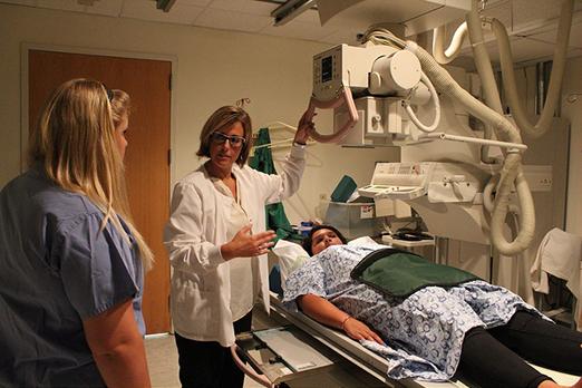 Students and instructor use medical imaging equipment