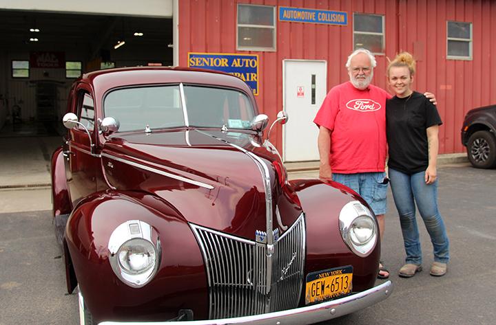 Abigail Clark and her grandfather Jim White stand outside the refinished 1940 Ford Coupe.