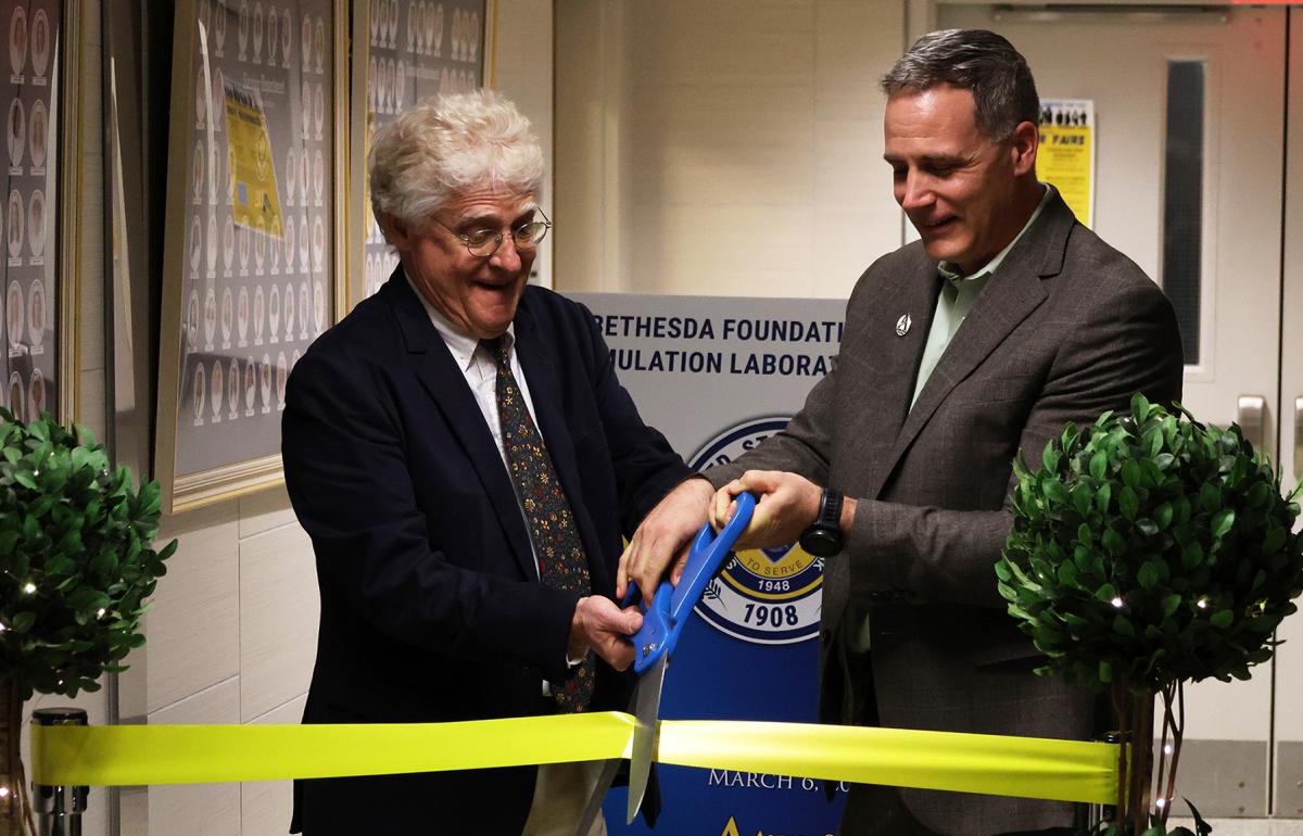 Dr. Mauro and Rob Price cut the ribbon of the new birthing simulator laboratory