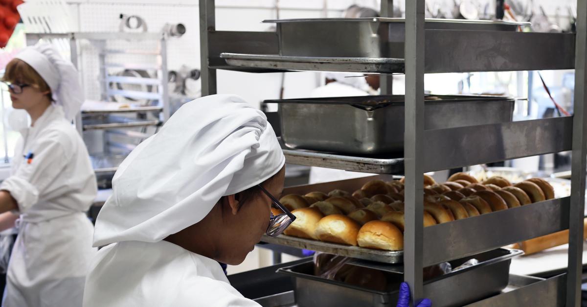 student works on rolls