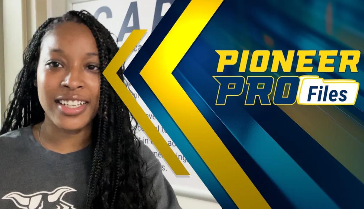 Student stands in student success center