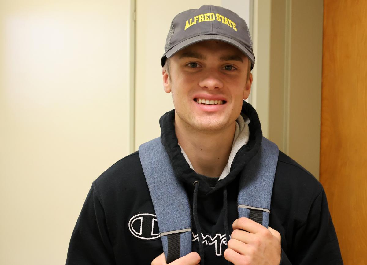 Student smiling in the hallway