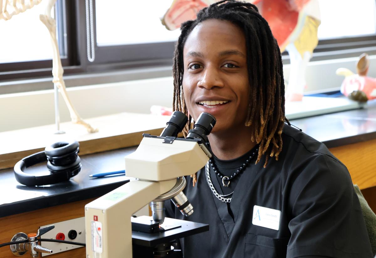 student works with a microscope