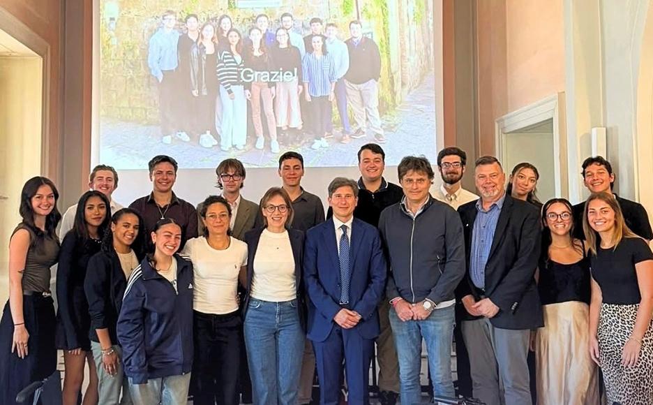 students pose after presenting in a class