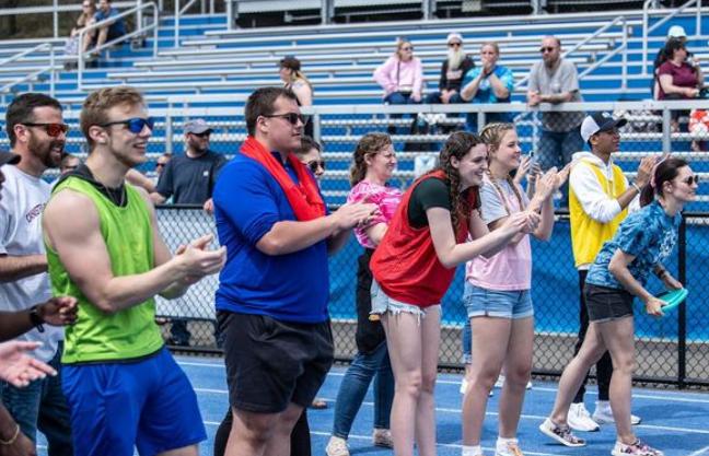 Students cheer on athletes at the finish line