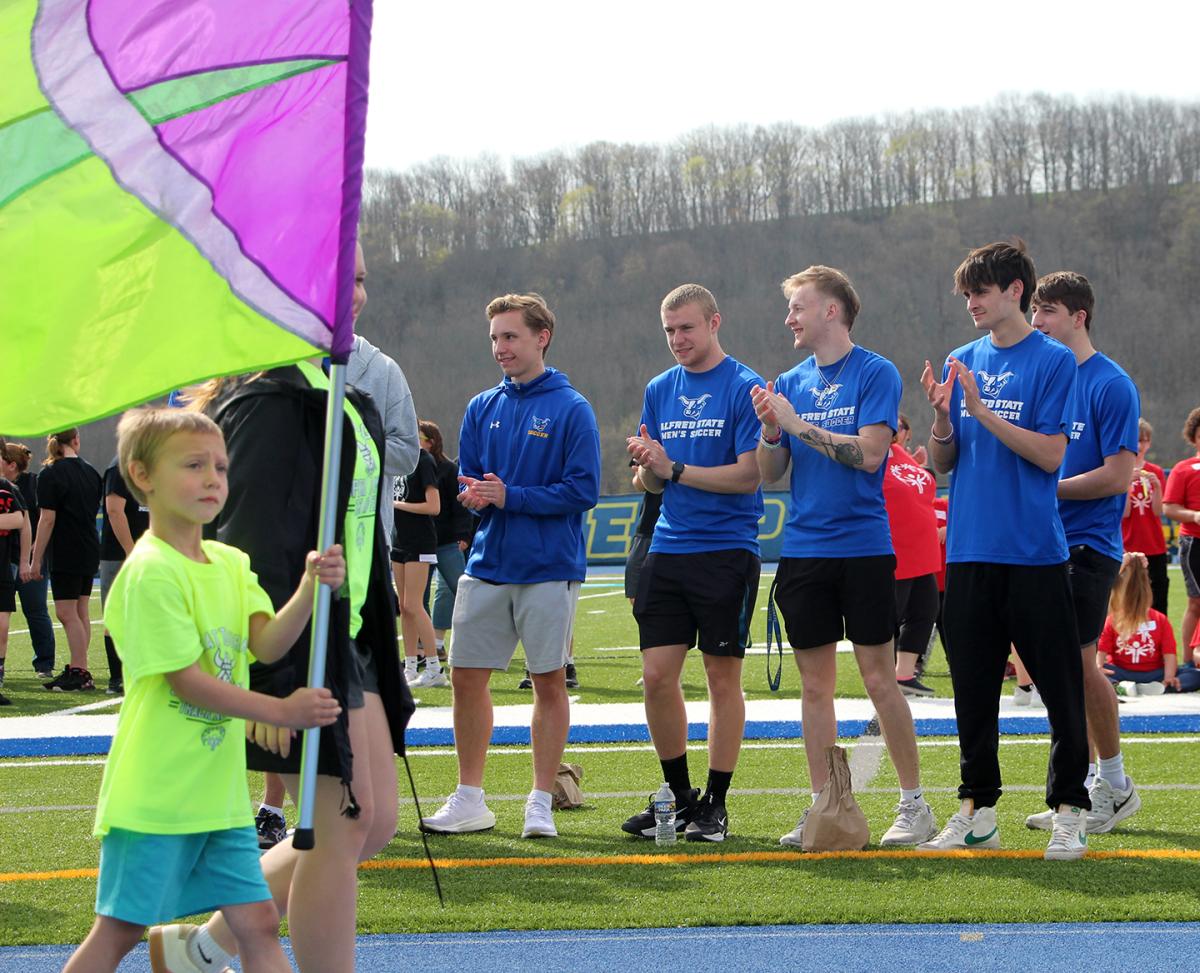 student-athletes cheer on special Olympic athletes