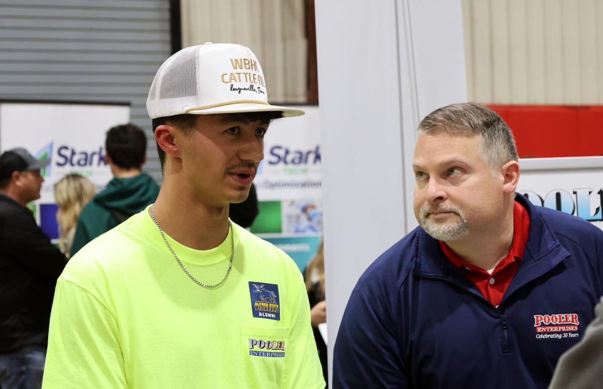 Noah Springer talks to current students at a career fair
