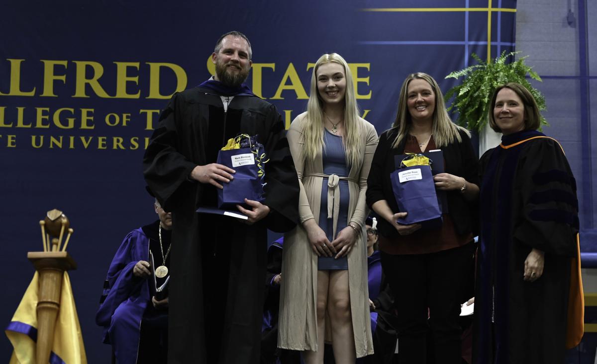 Mark Bloxsom and Jennifer Ross pose after getting an award